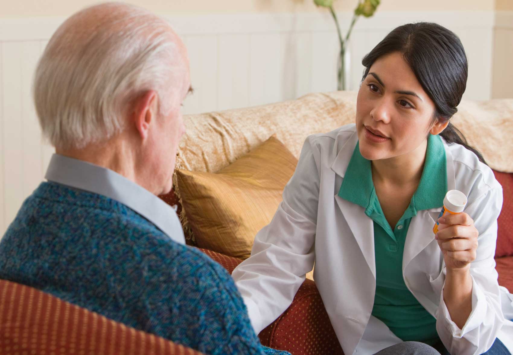 Hospice nurse telling a patient about a medication.